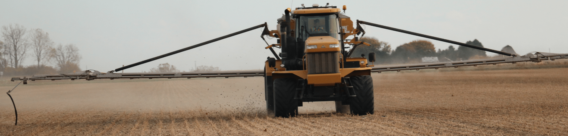 self-propelled crop sprayer with wide boom arms extended