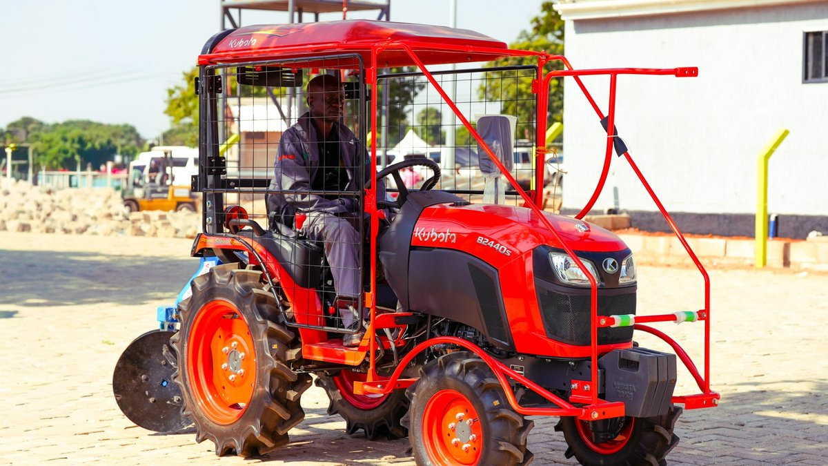 Red Kubota B2440S 24 HP compact 4WD tractor with protective cabin, designed for farming, cultivation and spraying in Tanzania.