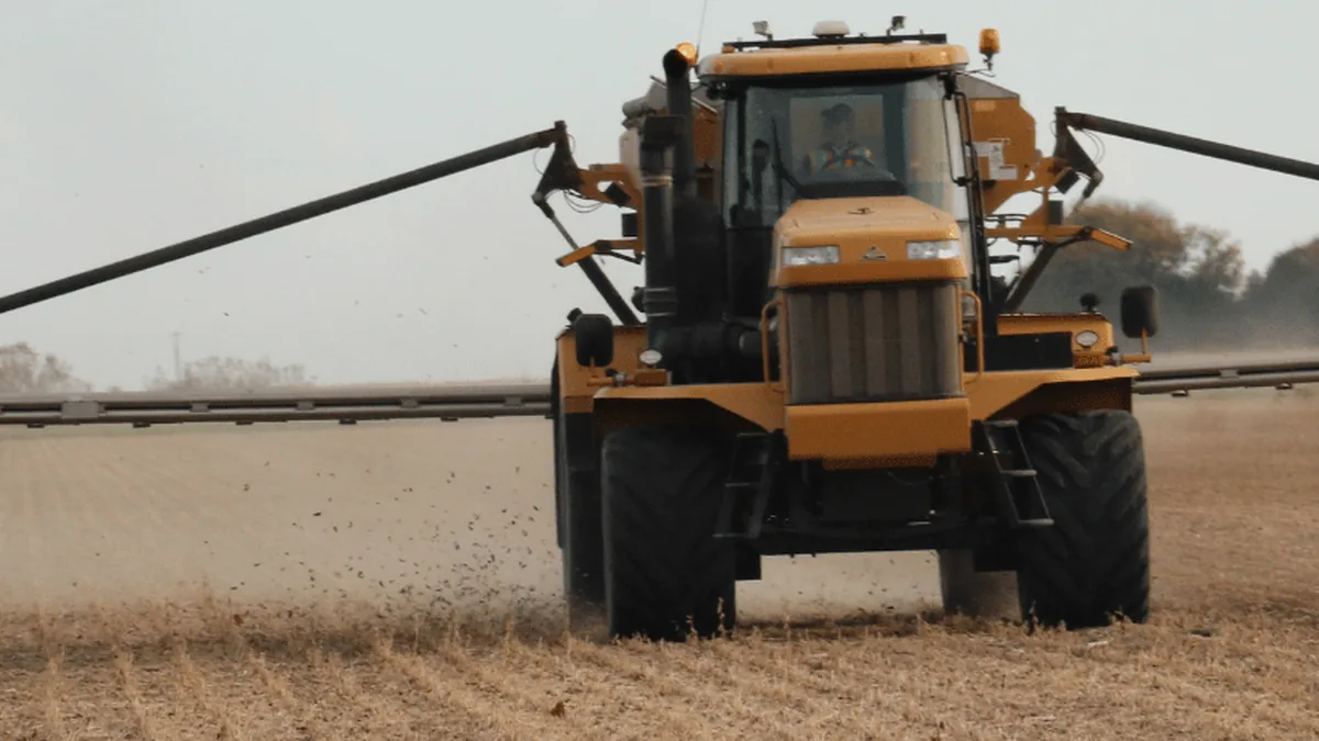 self-propelled crop sprayer with wide boom arms extended